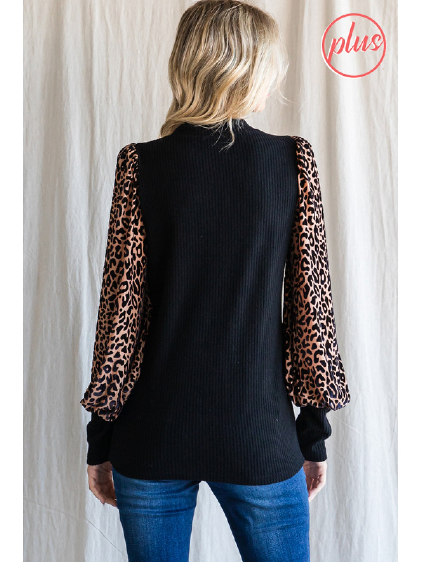 Solid knit top with leopard print sleeves